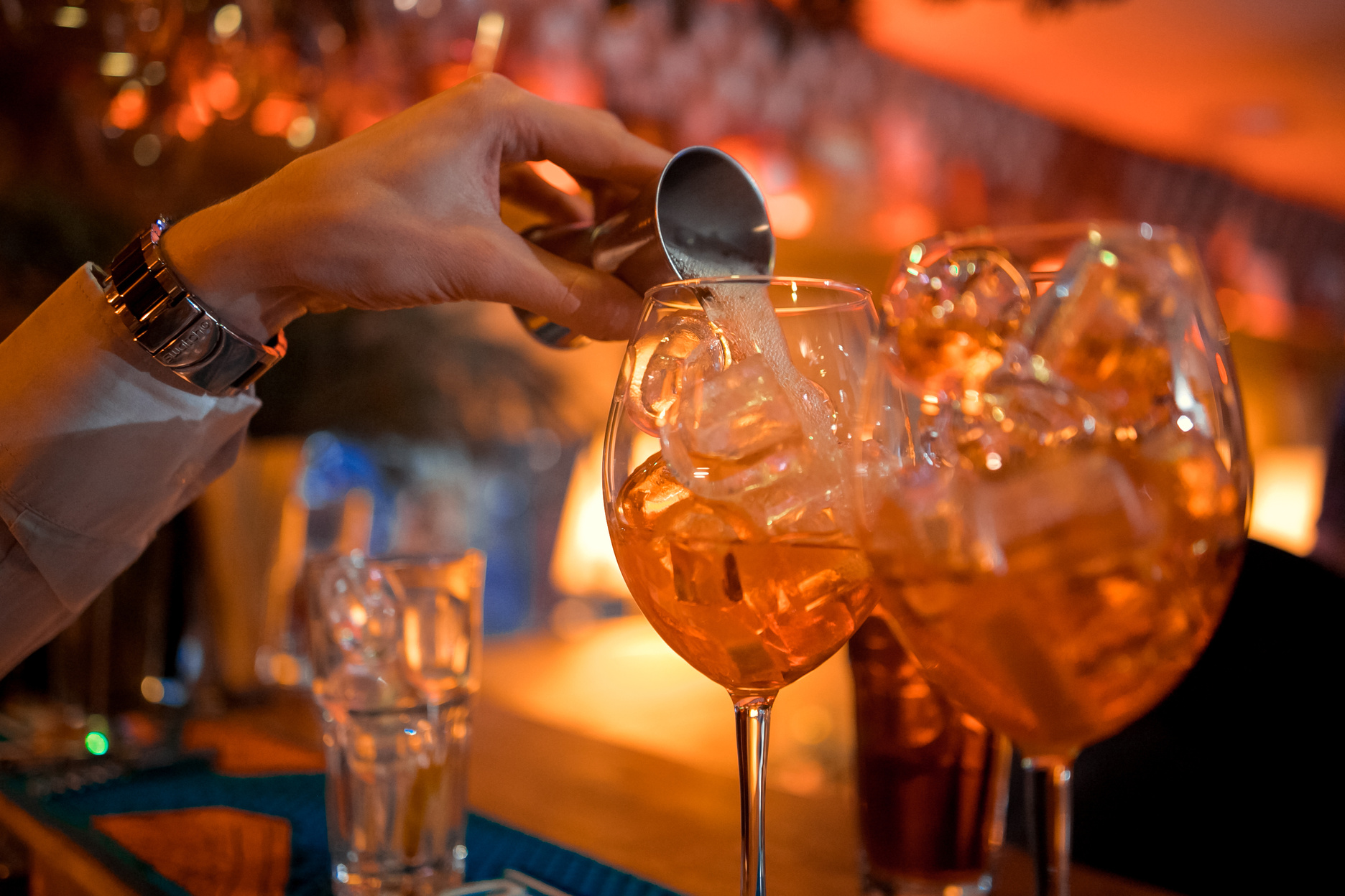 Bartender preparing alcoholic aperitif, aperol spritz cocktail